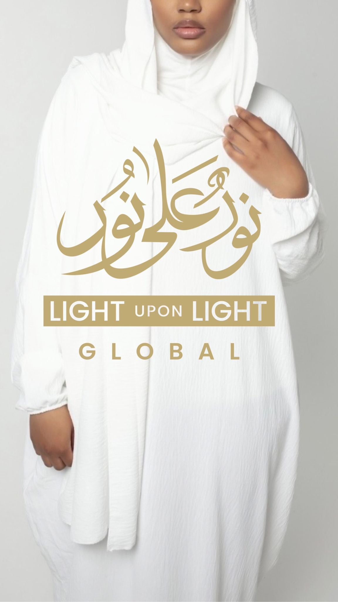 Person wearing a white garment with gold text and 'Light Upon Light Global' branding on a gray background